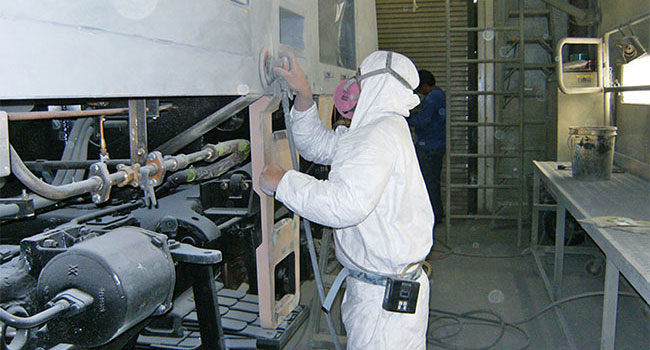 Industrial-Hygiene-worker-sanding-locomotive-larger