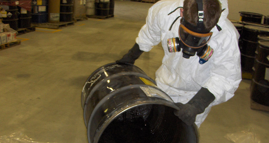 Worker-chemicals-in-barrel-large